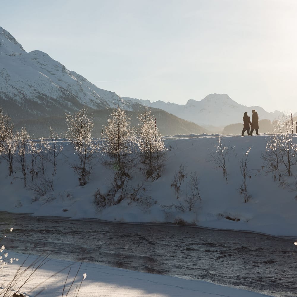 Winter hiking along the Inn in Samedan